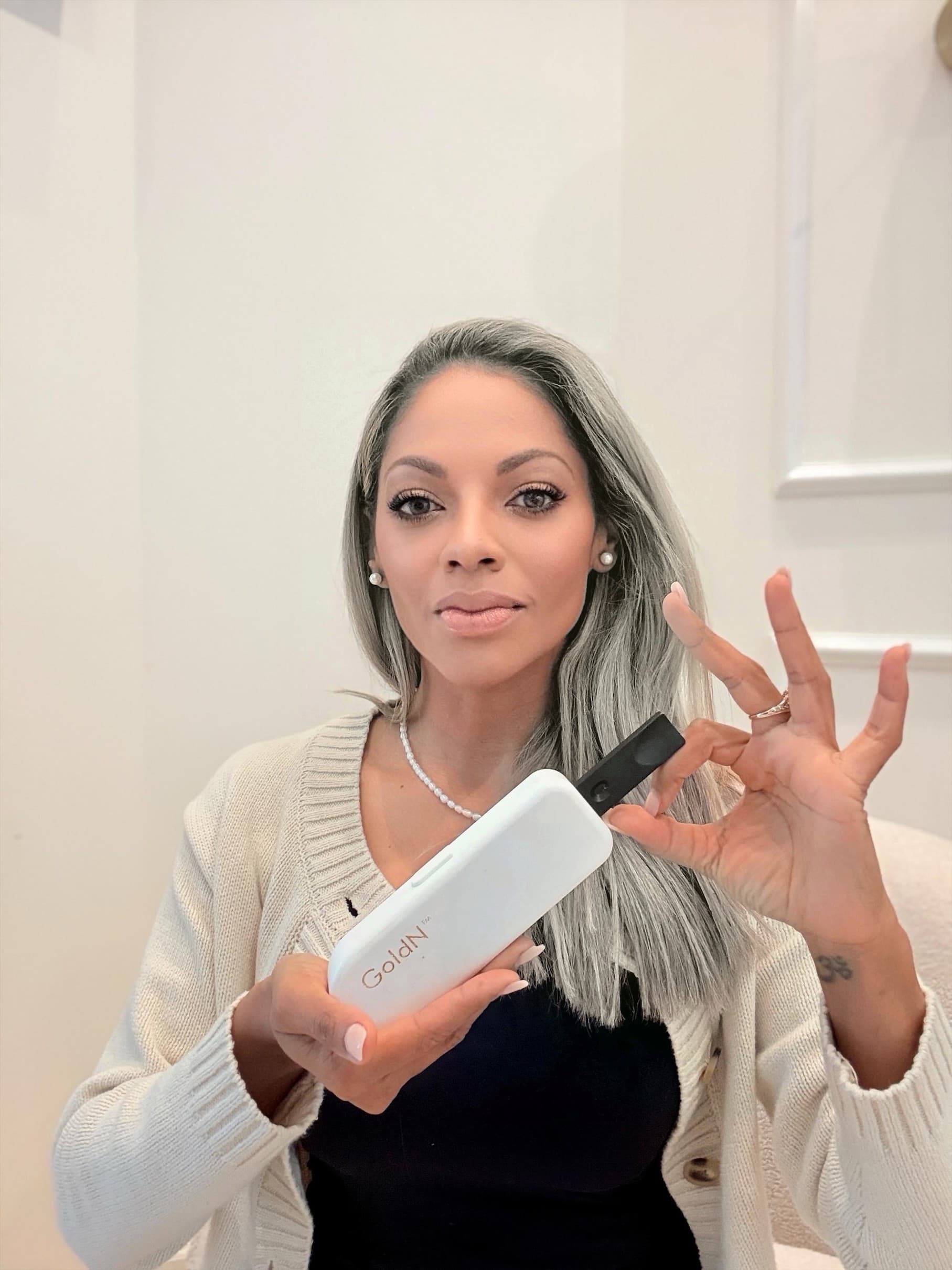 Nancy Torres, Founder and CEO of NOVODX, holding the GoldN Companion