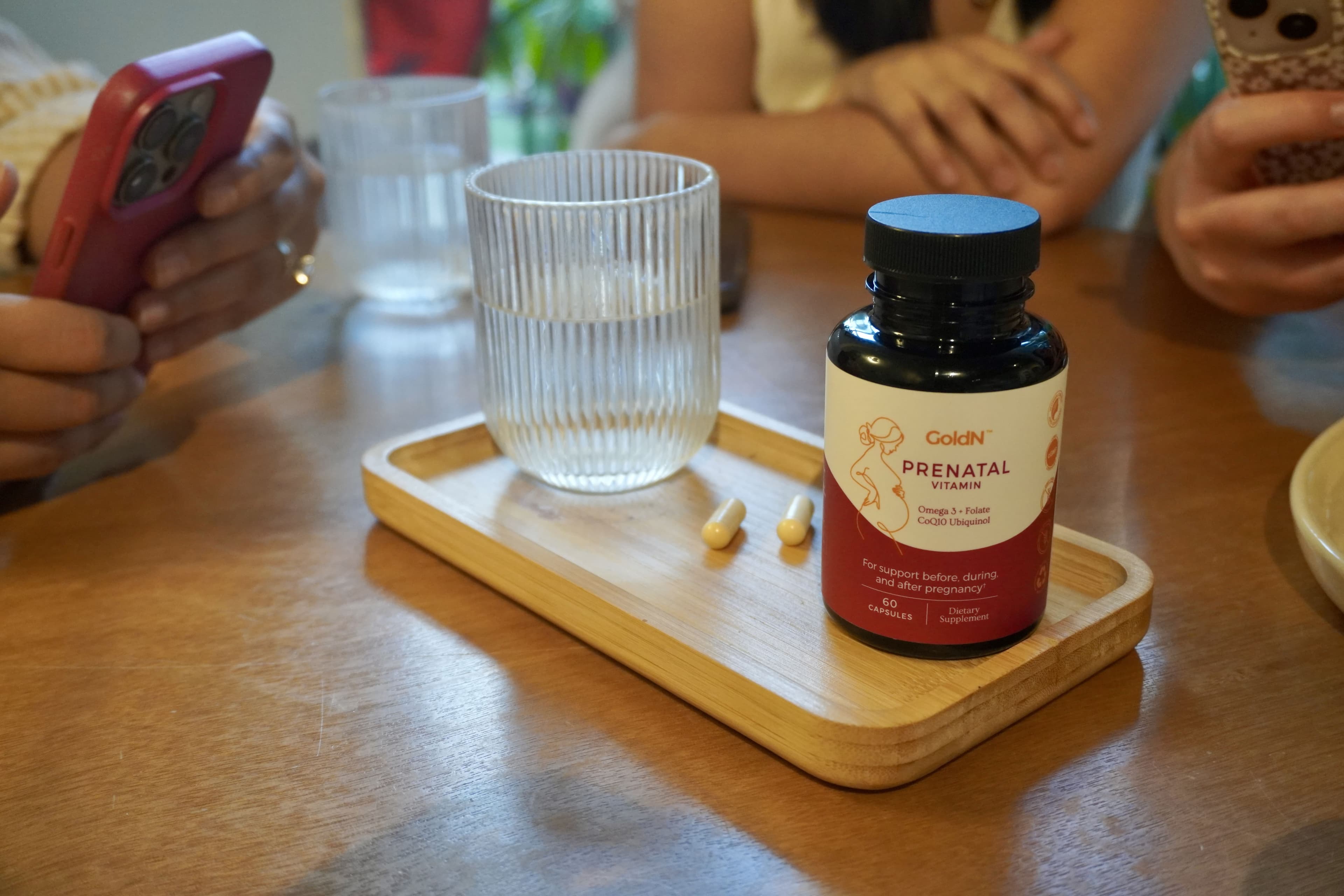 GoldN Prenatal bottle on a wooden tray