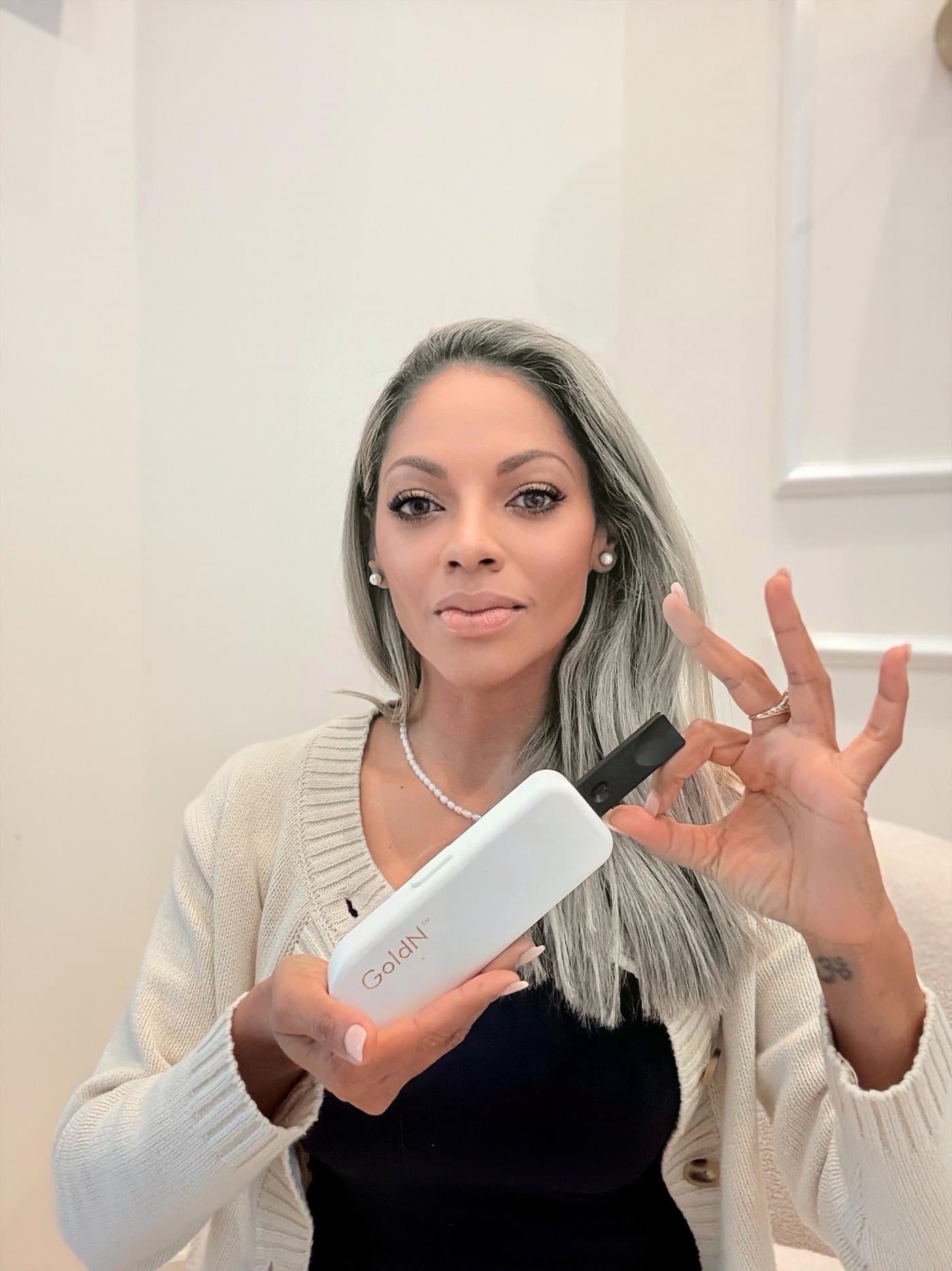 Nancy Torres, Founder and CEO of NOVODX, holding the GoldN Companion